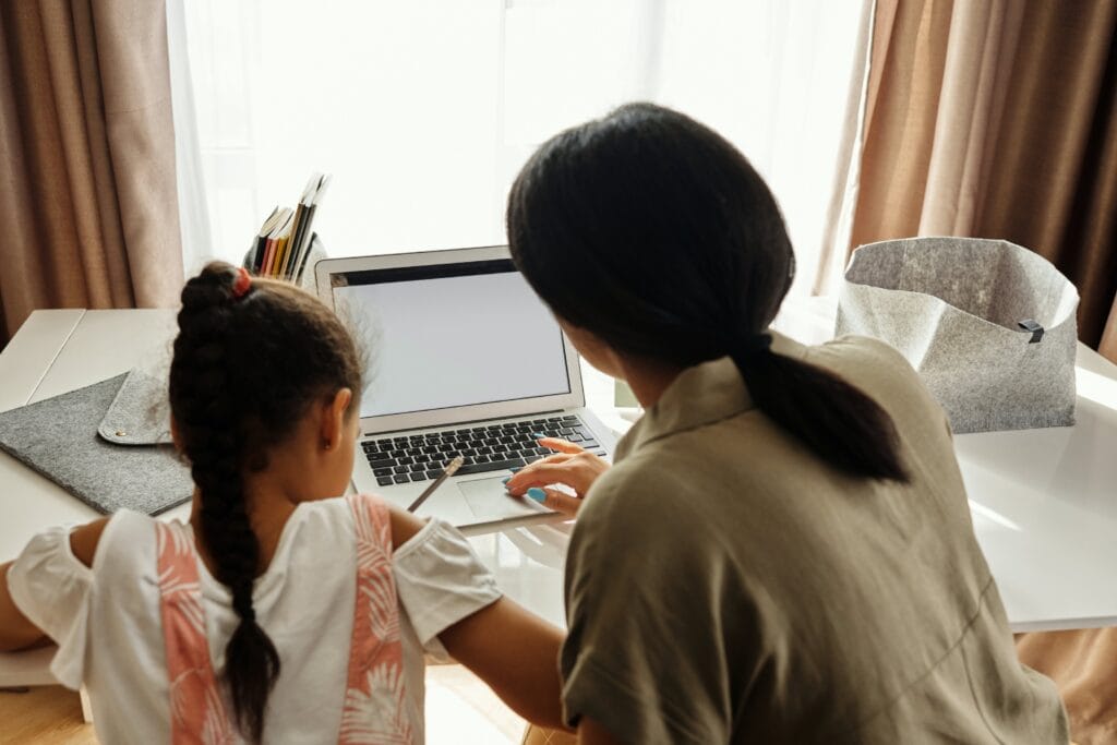 little girl and her mother doing homework
